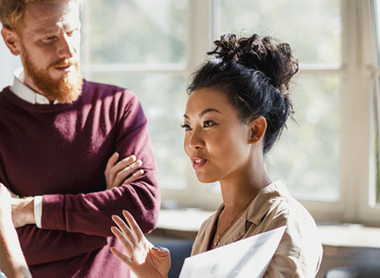 Woman talking to colleagues calmly