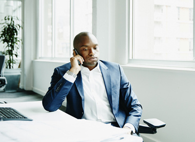 Man at work on the phone looking stressed