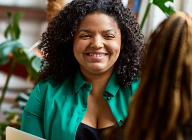 Woman being interviewed and smiling