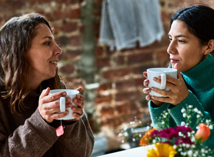 Two friends talking openly over a cup of tea