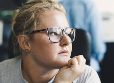 Woman at work looking unhappy