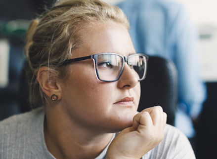 Woman at work looking unhappy