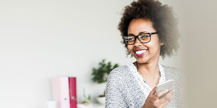 Woman smiling with a mobile phone