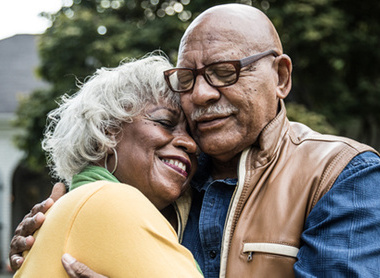 Older couple hugging and smiling