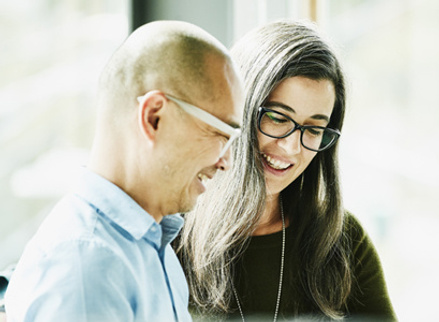 Two colleagues talking and going over a project