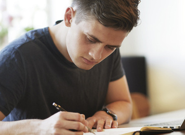 Man revising and writing down notes