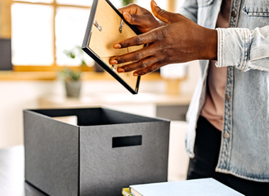 Person putting things off their desk in a box