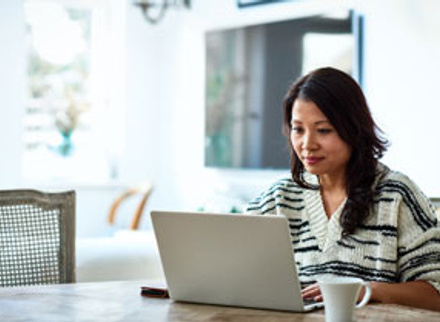 Woman looking happy on laptop